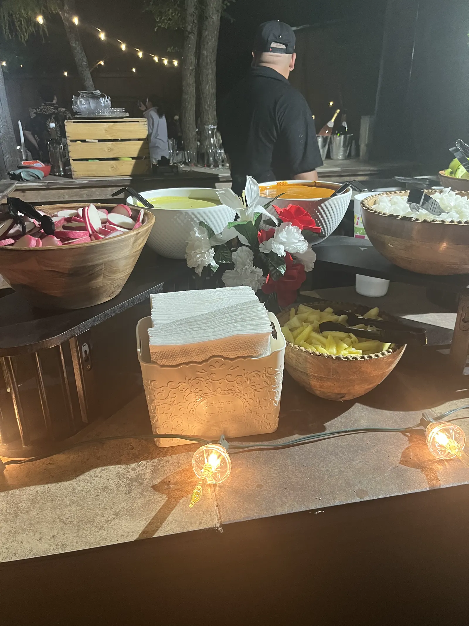 Antojitos Anthony's team serving food at a nighttime catering event